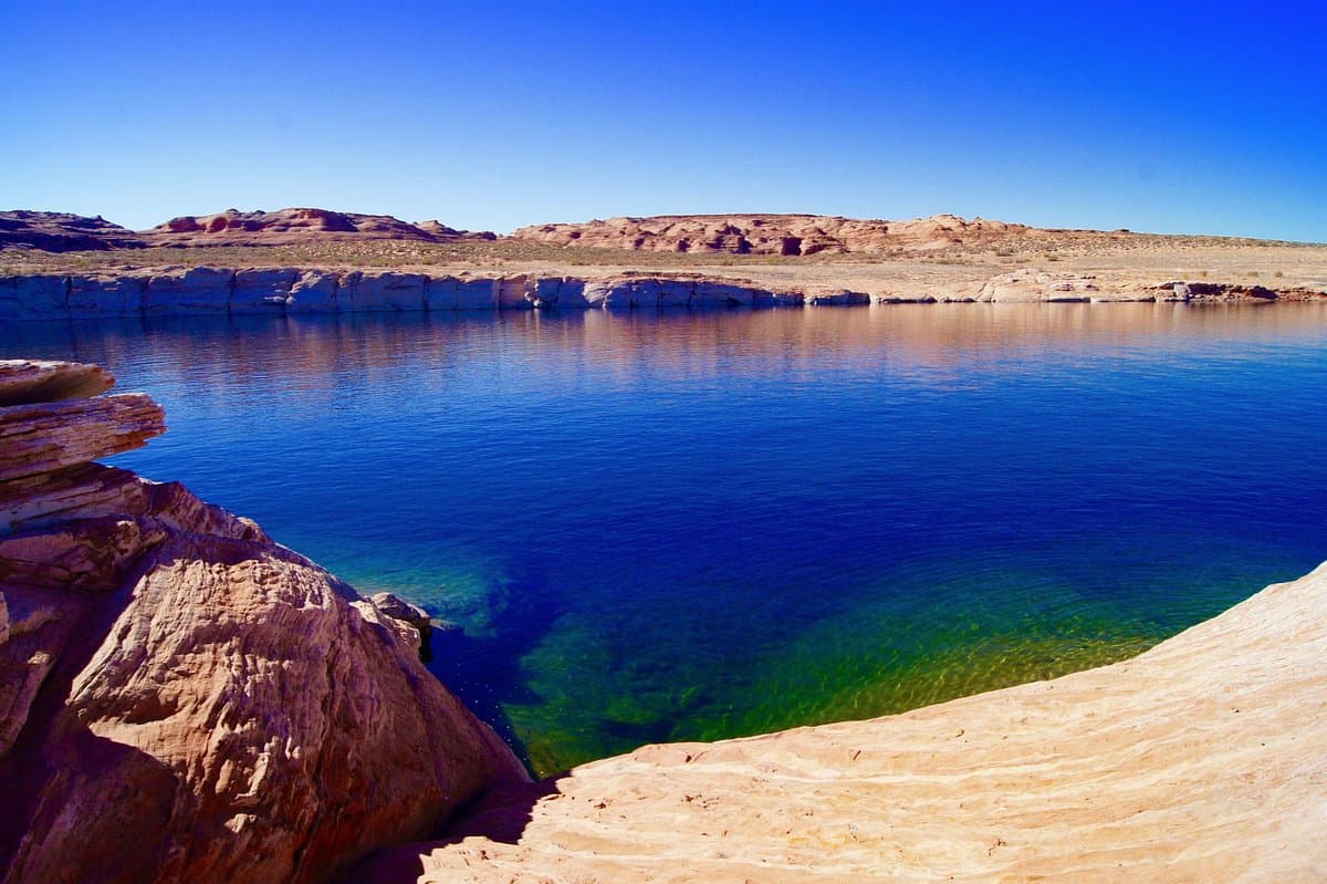 Sandstone shoreline meeting clear Lake Powell water